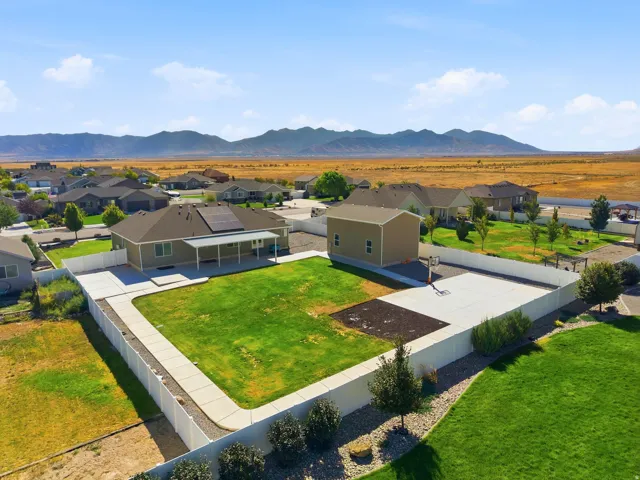 1/2 acre lot with riding track, game court and covered patio!