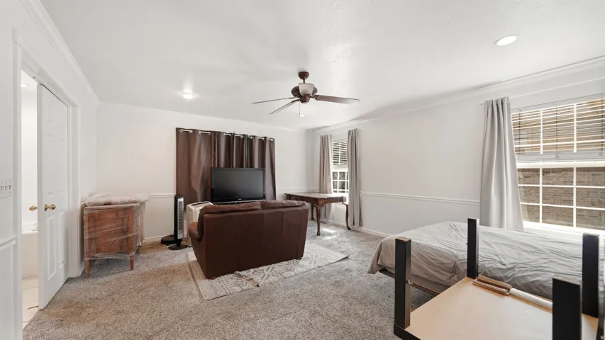 Master bedroom with recessed lighting, crown molding, and two paneled interior doors