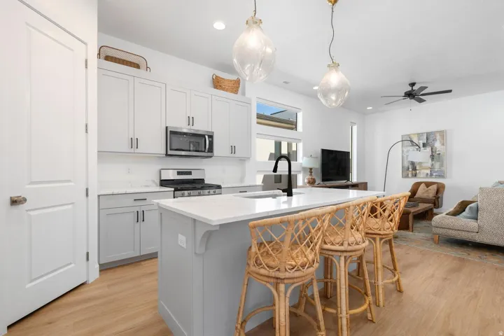 Kitchen island with a white countertop and a black gooseneck faucet