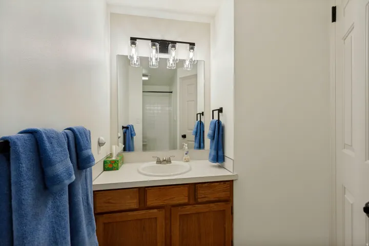 Vanity with wood-finish cabinetry and a single basin sink