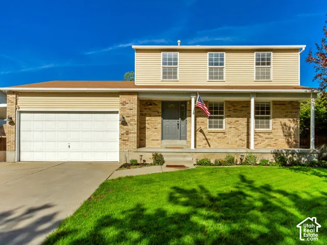 Two-story exterior with horizontal siding and brick accents