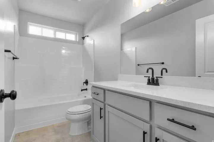Vanity with a light-colored countertop and dark-finished fixtures