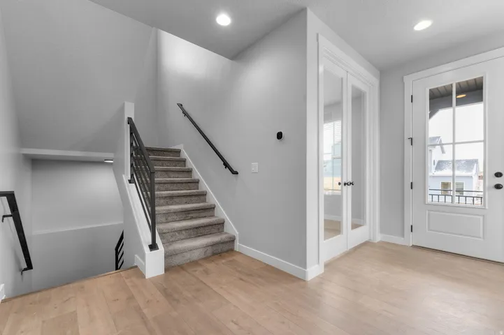 Light wood-finish flooring with a multi-pane glass-insert door