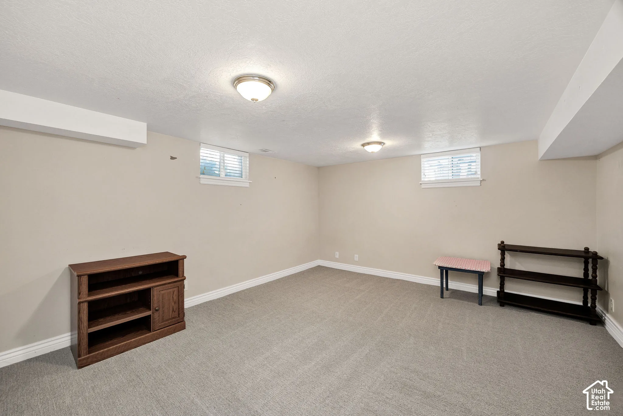 Carpeted room with neutral wall tones and white trim