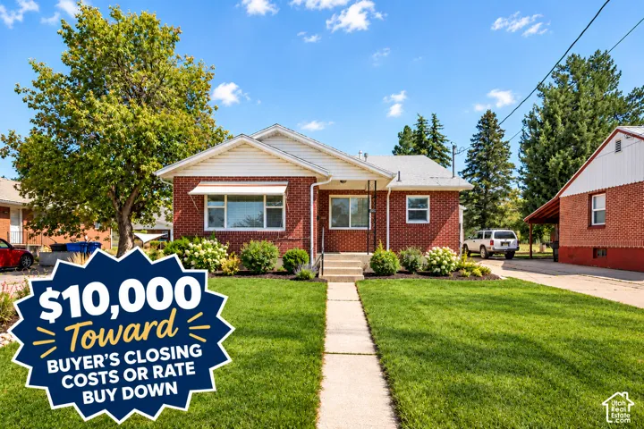 Brick exterior residence featuring a front-facing gable roof, concrete walkway, and private driveway