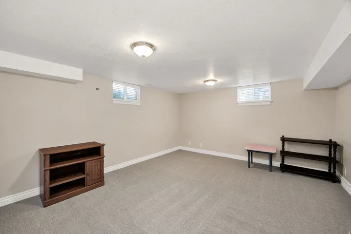 Carpeted room with neutral wall tones and white trim