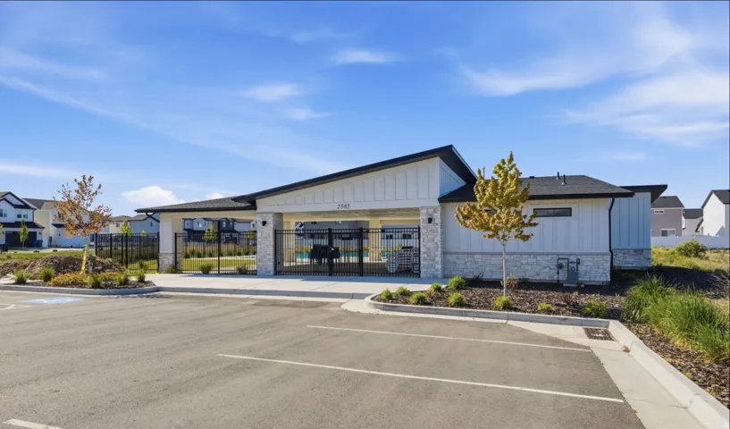 Modern community amenity building featuring board and batten siding, stone facade accents, and a covered entry