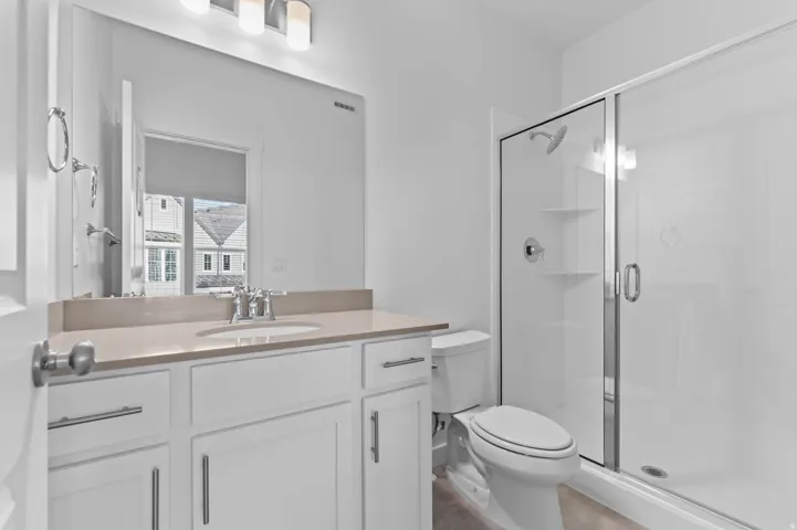 White vanity with a rectangular undermount sink and a light-colored countertop