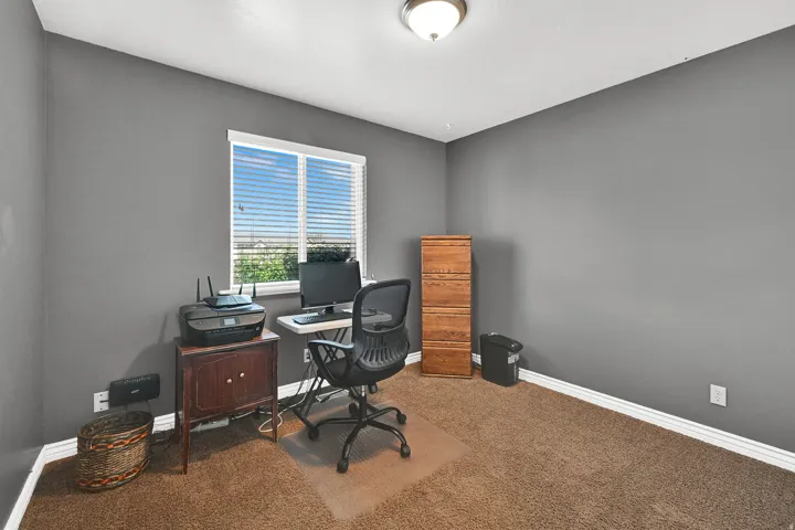 Window with horizontal blinds, neutral wall paint, overhead flush-mount lighting, and carpeted flooring