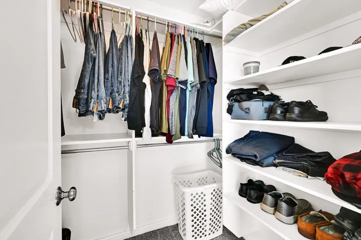 Built-in closet system with multiple shelving units and hanging rods