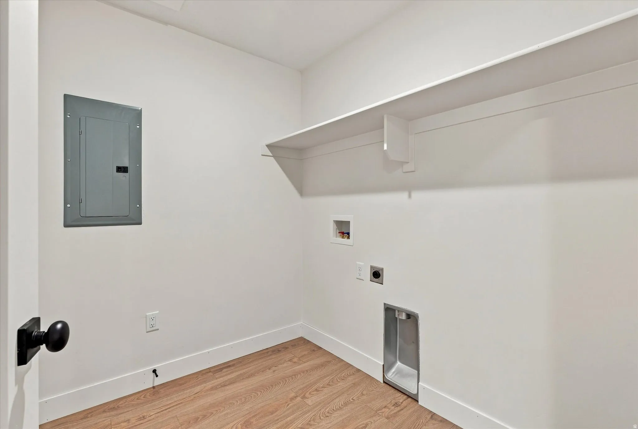 Wood-finish flooring, built-in shelving, and a clean white wall finish