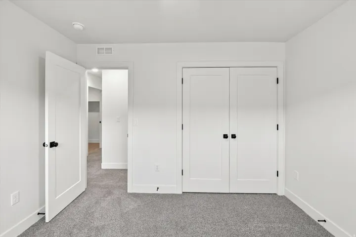 Neutral color palette with light gray carpeting