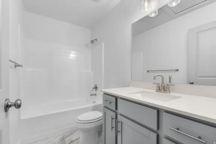 White subway tile shower surround with a built-in tub