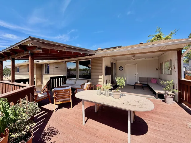 Multi-level wood-finish deck with a covered patio area