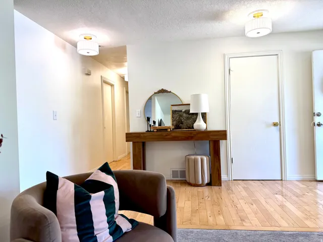 Wood-finish flooring throughout, complemented by white walls and ceiling