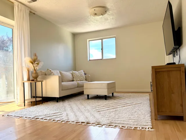 Hardwood flooring, painted walls, ceiling-mounted lighting, and a window for natural light
