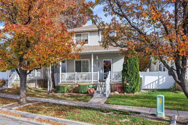 Light gray siding exterior with a covered front porch featuring white railings
