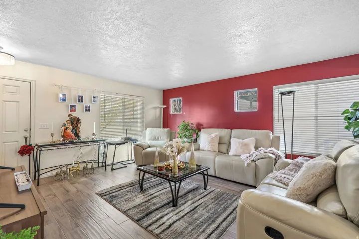 Wood-finish flooring throughout, complemented by a vibrant accent wall