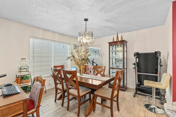 Recessed lighting, wood-finish flooring, and a contemporary chandelier