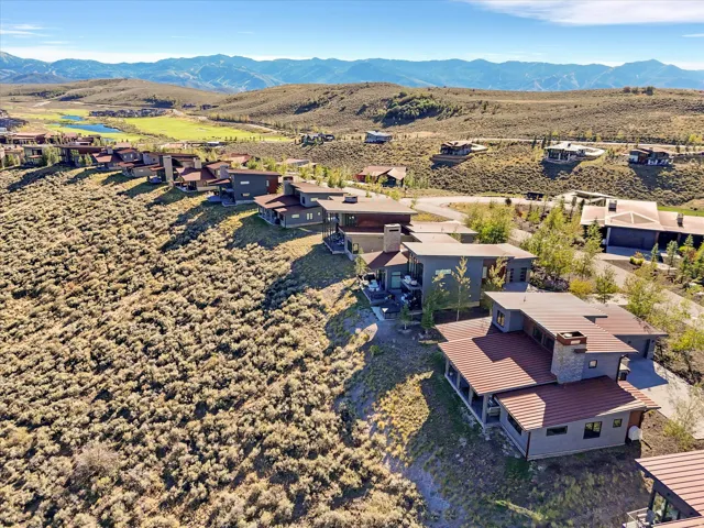 Modern residential structures with varied rooflines, multi-level designs, and stone accents
