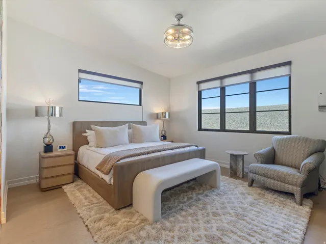 Recessed lighting, wood-finish flooring, and a modern ceiling fixture