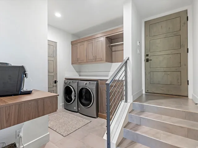 Laundry area with wood-finish cabinetry, white countertop, and tiled flooring