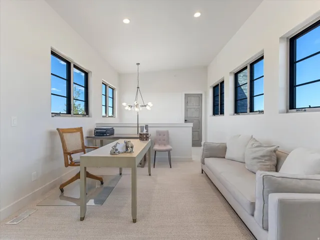 Open-concept space with multiple transom windows, recessed lighting, and a modern chandelier