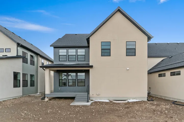 Contemporary exterior with a two-tone stucco and siding finish