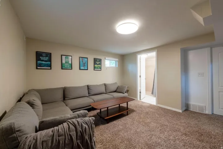 Recessed ceiling light fixture, neutral wall paint, carpeted flooring, white trim, white paneled doors