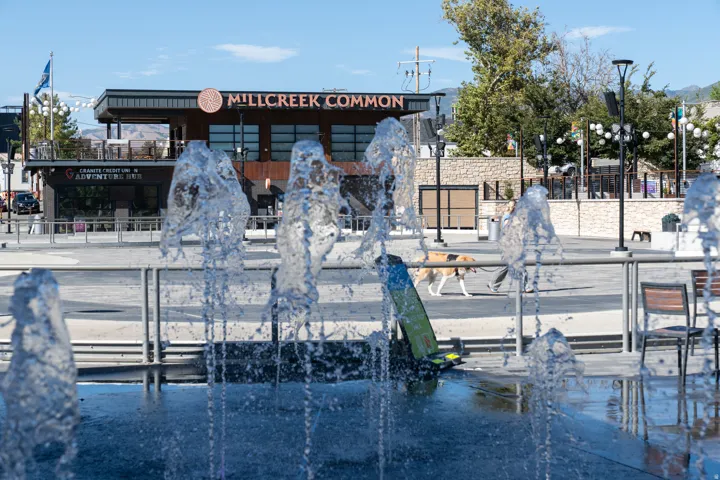 Water feature with multiple jets, surrounded by a paved hardscape