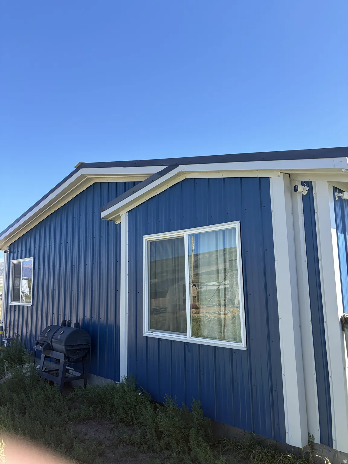 Blue corrugated metal siding with white trim