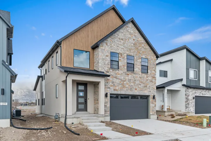 Contemporary exterior featuring stone and wood-finish siding