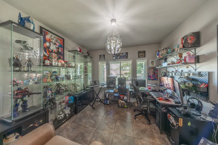 Bright and versatile flex space featuring abundant natural light and durable tile flooring—ideal for a home office, formal living room, creative studio, or hobby room.
