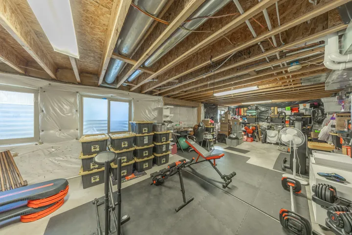 Expansive unfinished basement offering abundant storage and exceptional potential for future living space, a home gym, recreation room, or workshop—complete with framing, insulation, HVAC, and plumbing in place for a future bathroom.