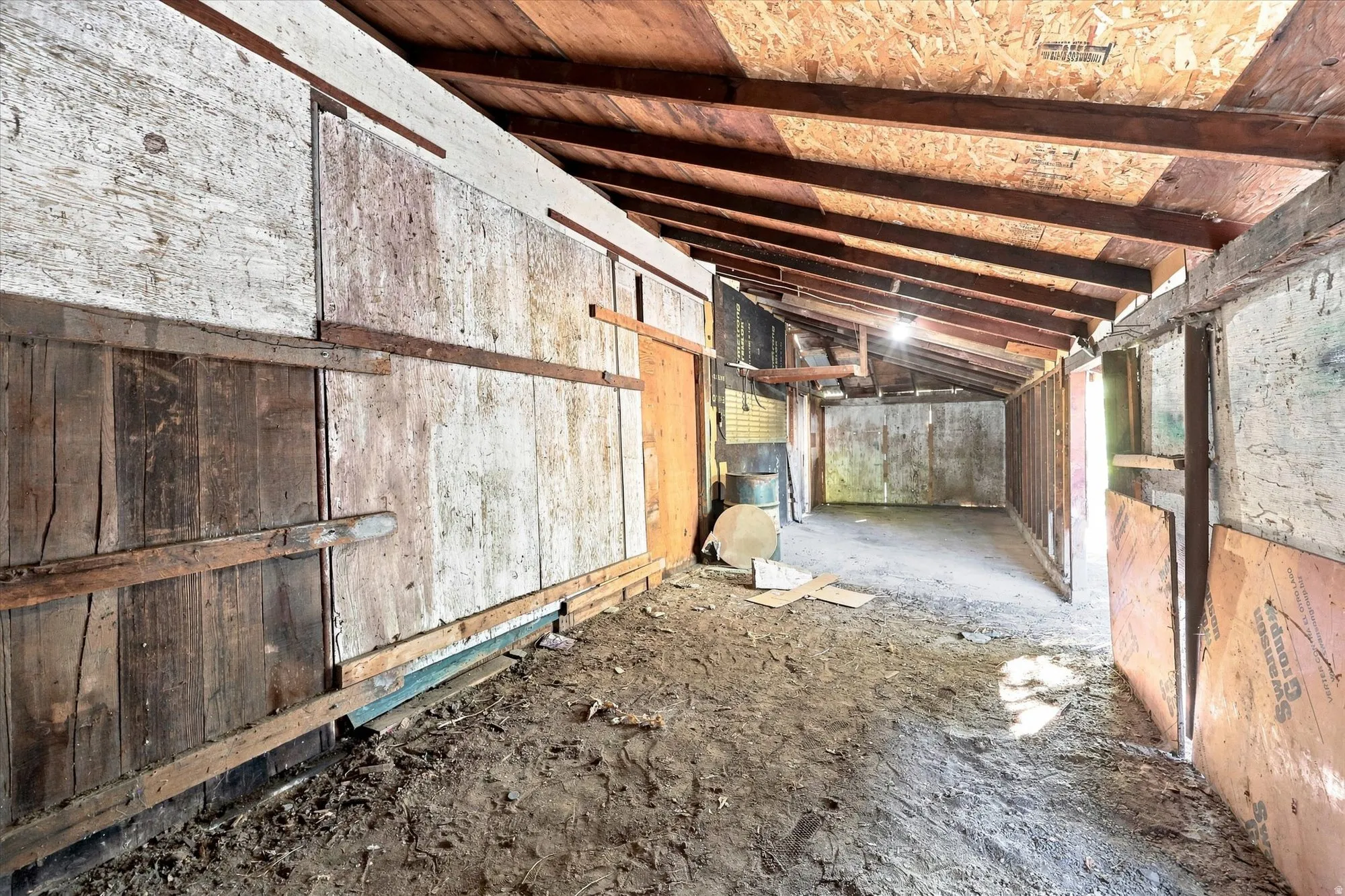 Exposed wood beam ceiling, wood-paneled walls, and open-air structure