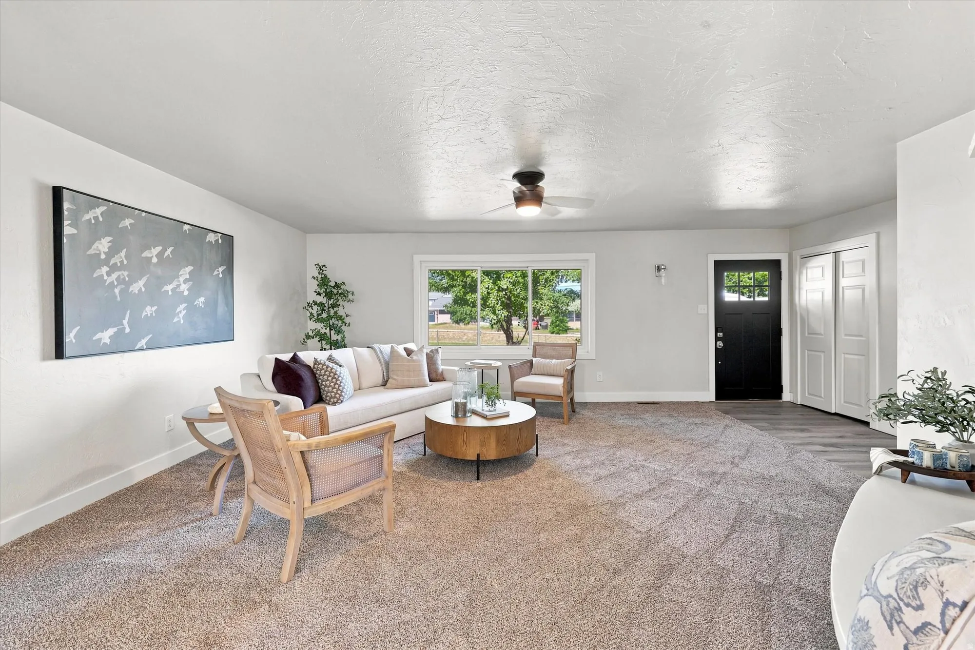 Recessed lighting, wood-finish flooring, a ceiling fan, and a black paneled entry door with glass inserts