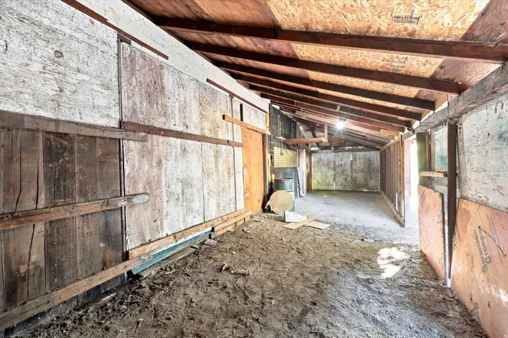 Exposed wood beam ceiling, wood-paneled walls, and open-air structure