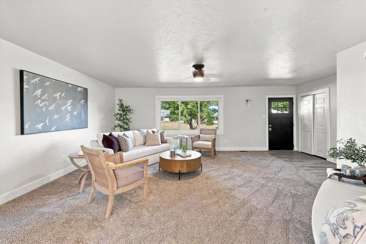 Recessed lighting, wood-finish flooring, a ceiling fan, and a black paneled entry door with glass inserts