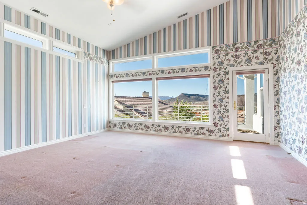 Vaulted ceiling, expansive windows, transom windows, and a glass-paneled door