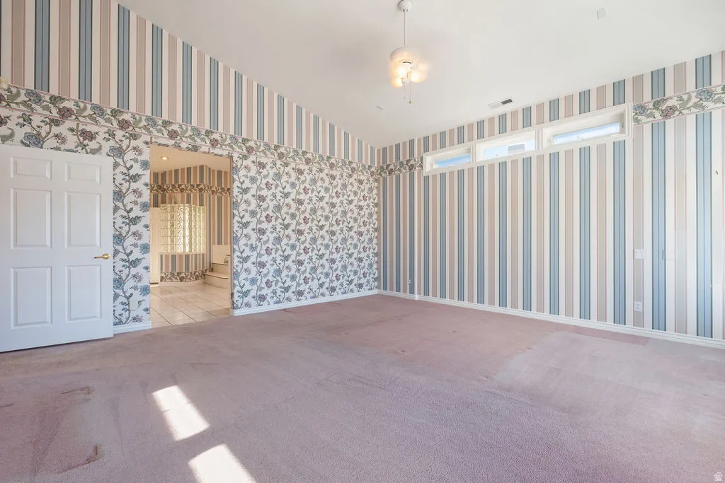 Vaulted ceilings, transom windows, flush-mount lighting, and a six-panel door