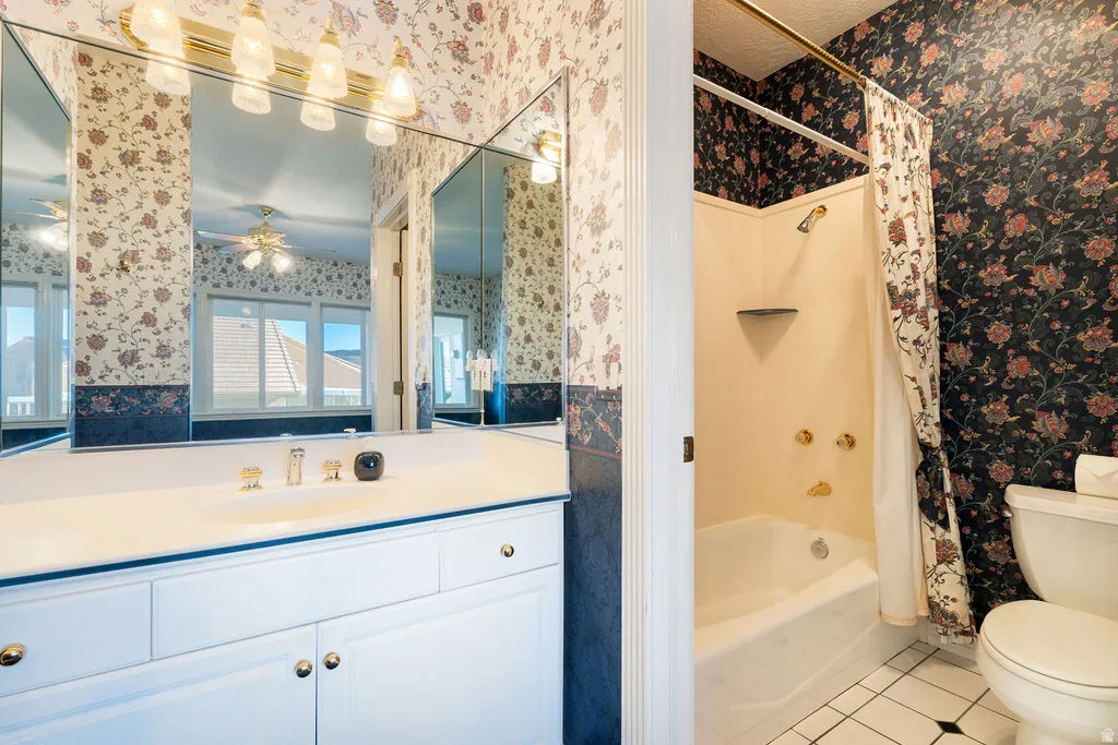 White vanity with gold-tone hardware, integrated sink, and mirrored wall