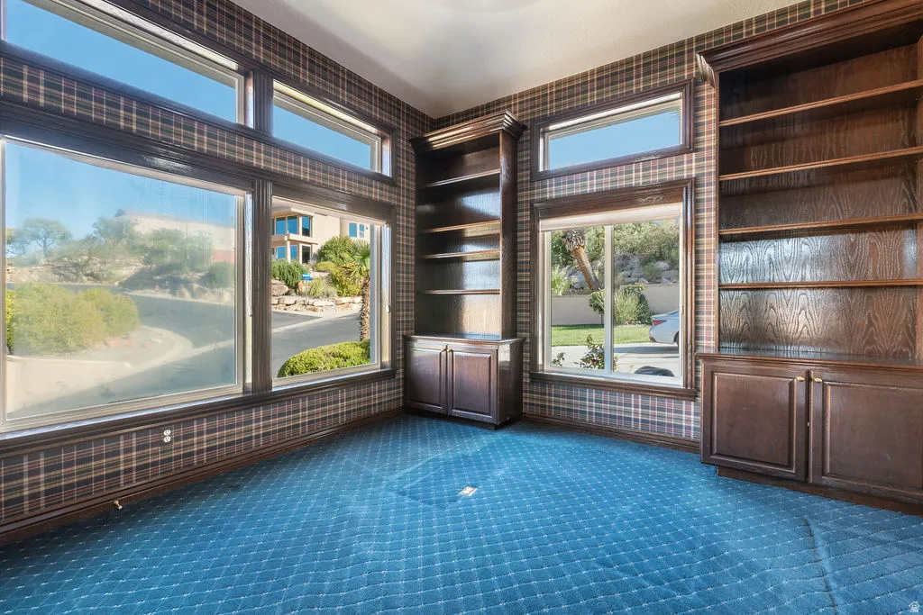 Built-in custom cabinetry, integrated shelving, and large windows with transom accents