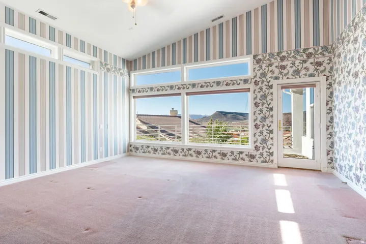 Vaulted ceiling, expansive windows, transom windows, and a glass-paneled door