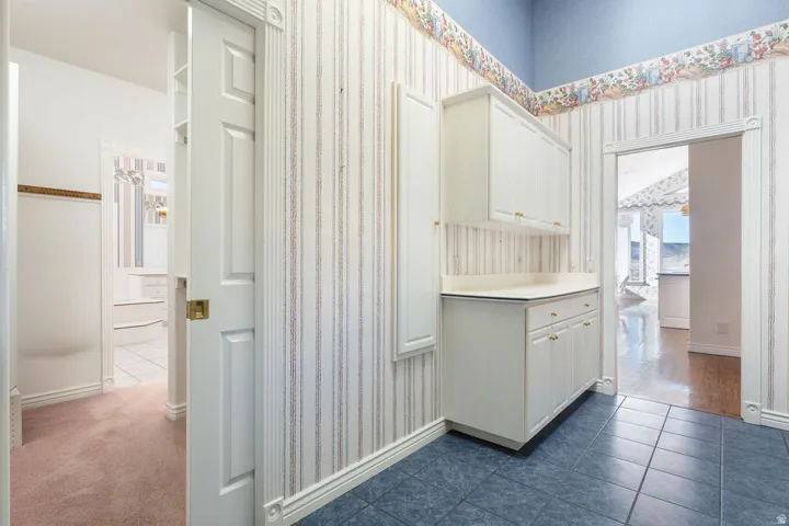 Built-in cabinetry with beadboard doors and a light-colored countertop