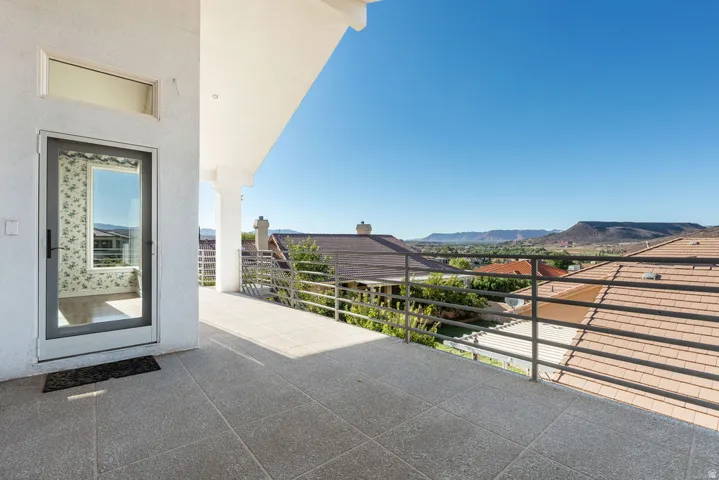 Expansive tiled balcony with modern metal railings, providing a desert mountain backdrop