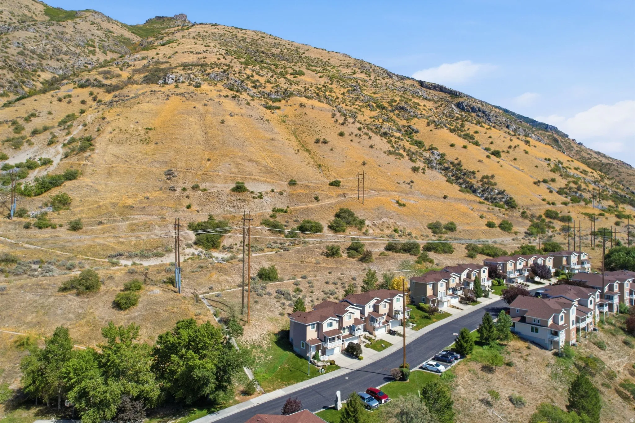 Residential community with multi-story townhomes and a paved roadway