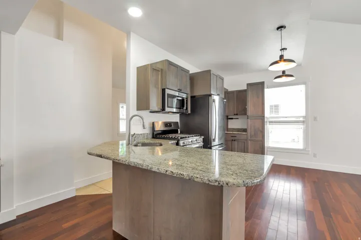 Kitchen island with a granite countertop and an undermount sink