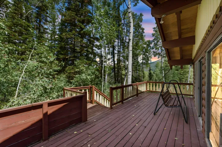 Expansive outdoor deck with wood-finish flooring and railing