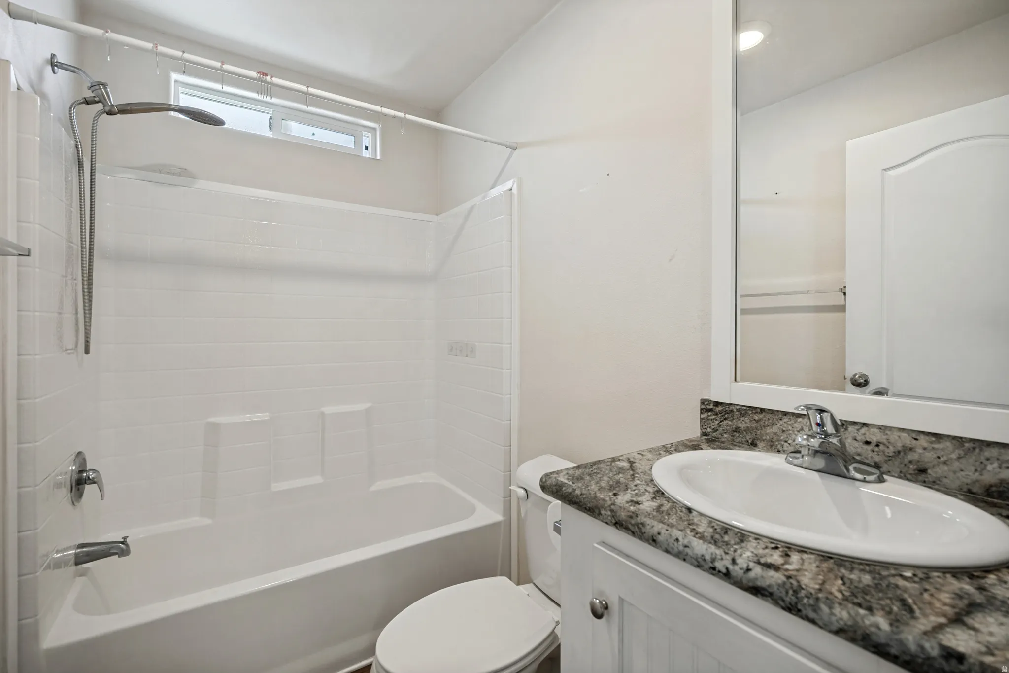 White vanity with beadboard paneling, granite-style countertop, and drop-in oval sink