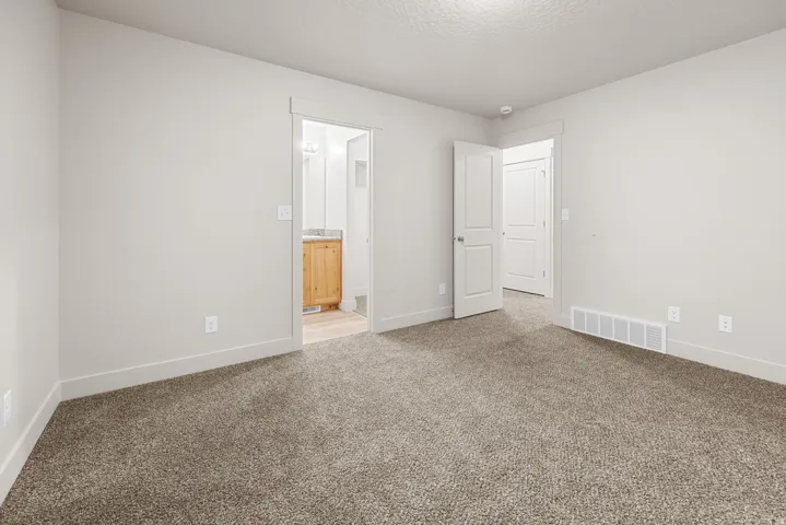 Neutral wall paint colors, textured carpeting, recessed ceiling lighting, and solid core doors